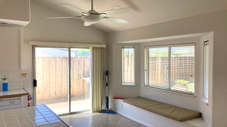 Bright kitchen - lots of windows!  Bay window seating area with ceiling fan overhead as well as sliding glass door - keeps the kitchen low-odor when cooking a meal where the smell could otherwise get a little intense.  Cathedral ceiling makes for a spacious feel.