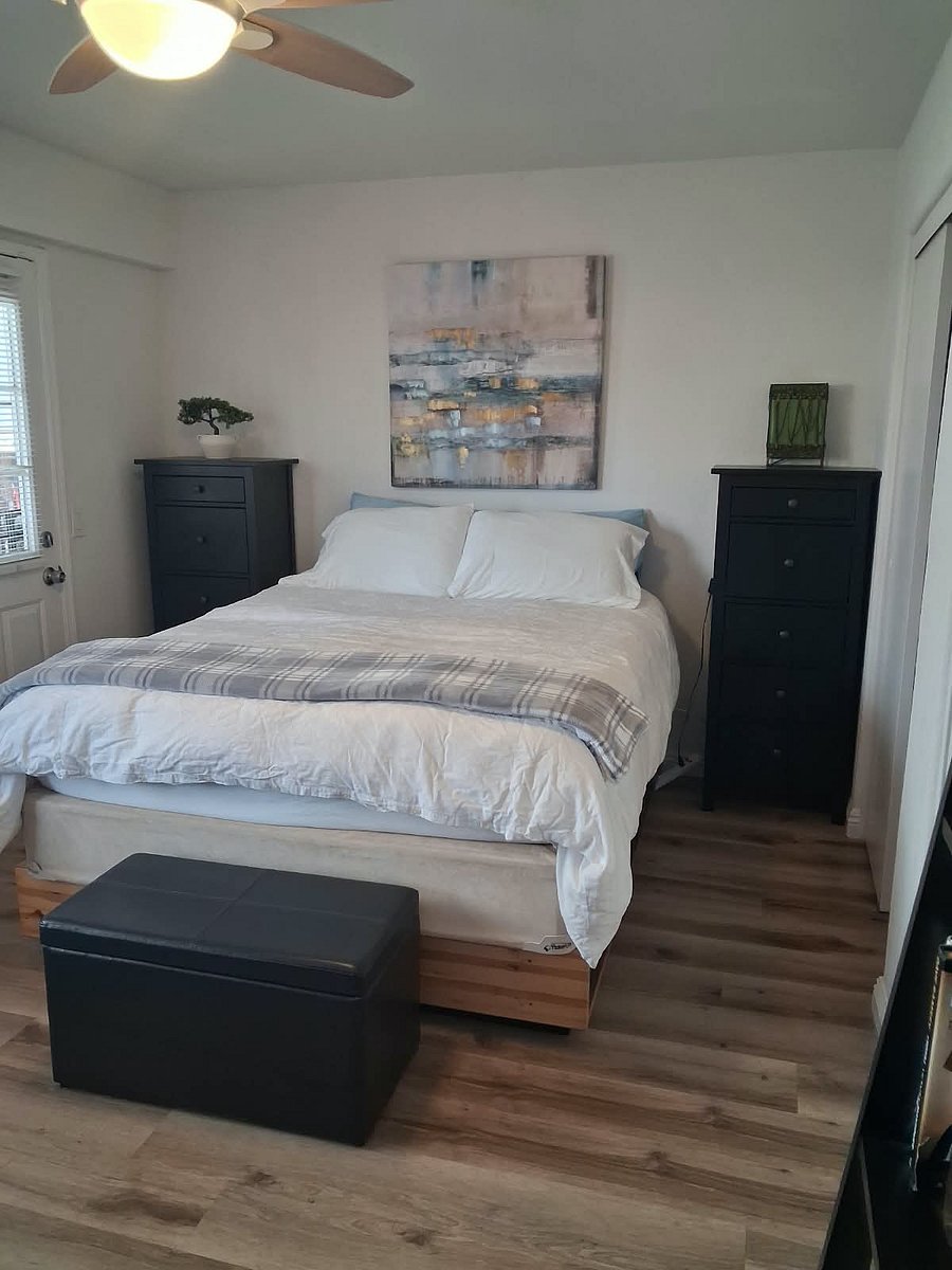 3rd Bdrm - extra long - effectively a 2nd master bedroom with its own exterior door access. Queen-sized mattress with thick foam. TV and full-sized dresser, plus, 2 tall thin dressers and 2 separate closets. Leather bend at end of bed with storage space.