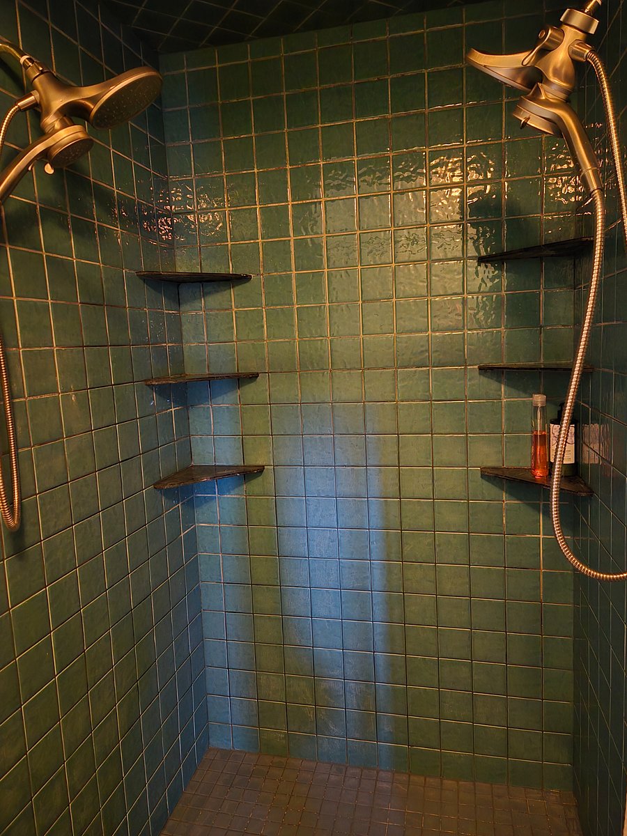 Two headed shower with spray heads and room for two.