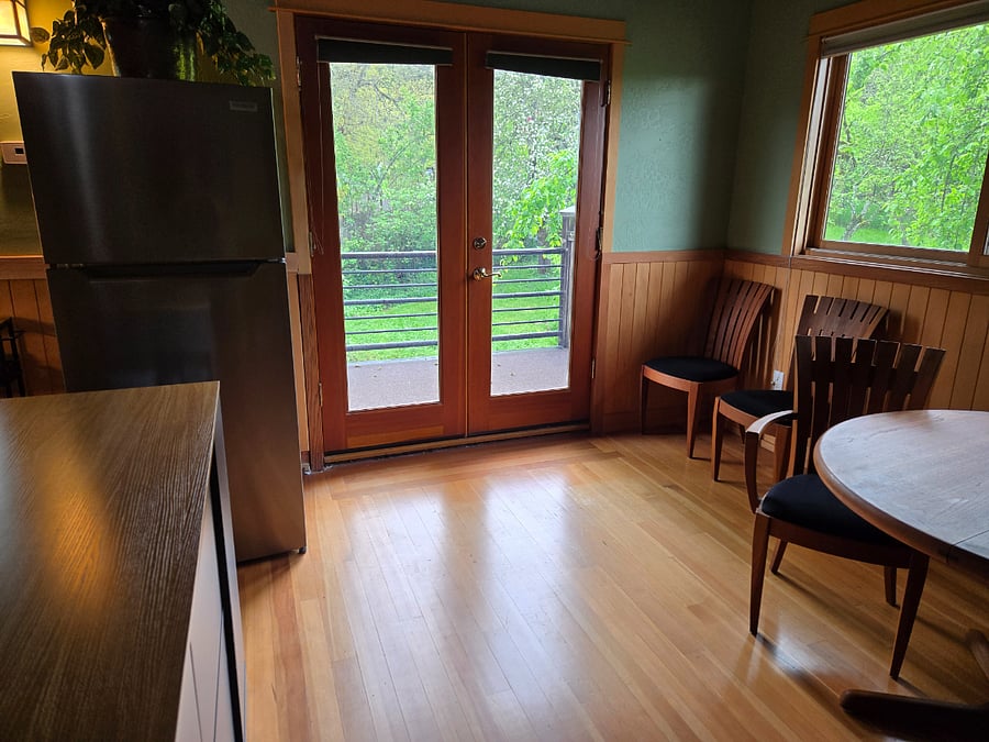 Kitchen on the left, eat in on the right, and doors to balcony.