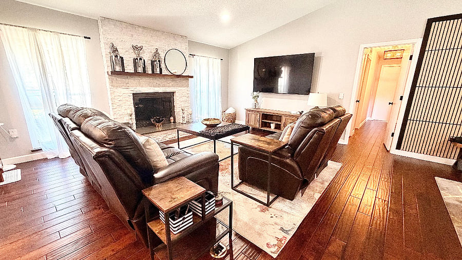Comfortable living room with fireplace and large mounted TV.