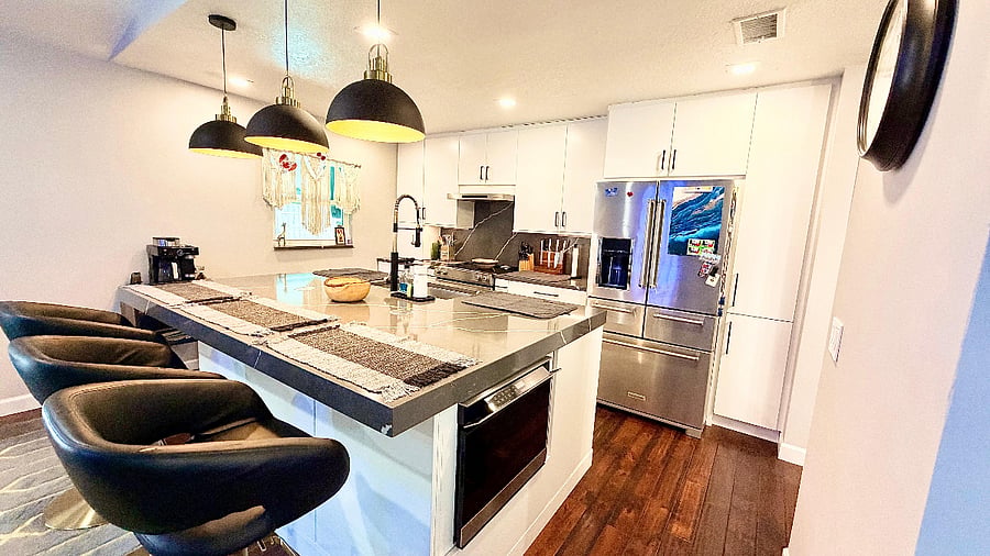 Fully renovated kitchen with oversized island and seating for three.