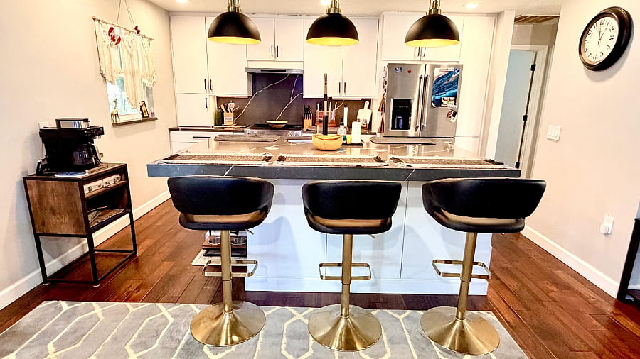Kitchen bar seating with modern lighting and open layout.