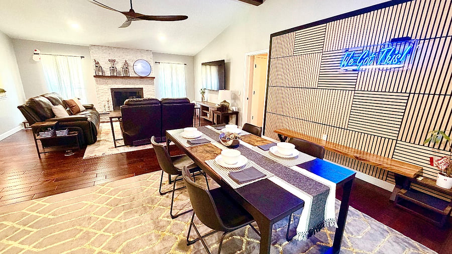 Dining area with seating and statement wall.