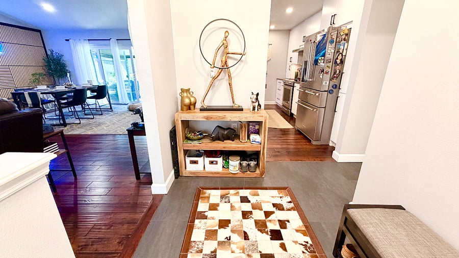 Open-concept entrance with lamp statue man. 