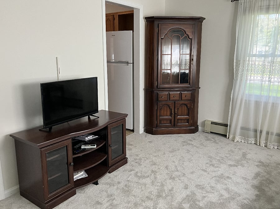 TV on stand and corner hutch