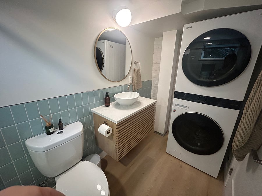 The in-unit washer and dryer are concealed behind the bathroom door.