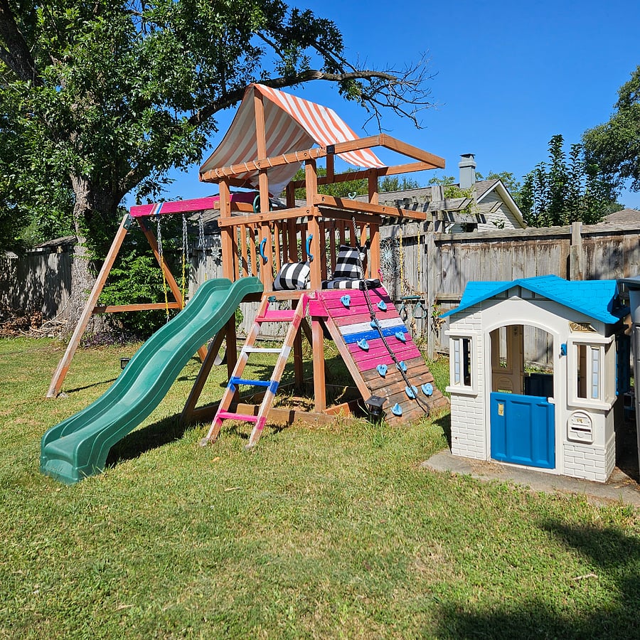 Play area for children. There is also a climbing dome and a see-saw now.