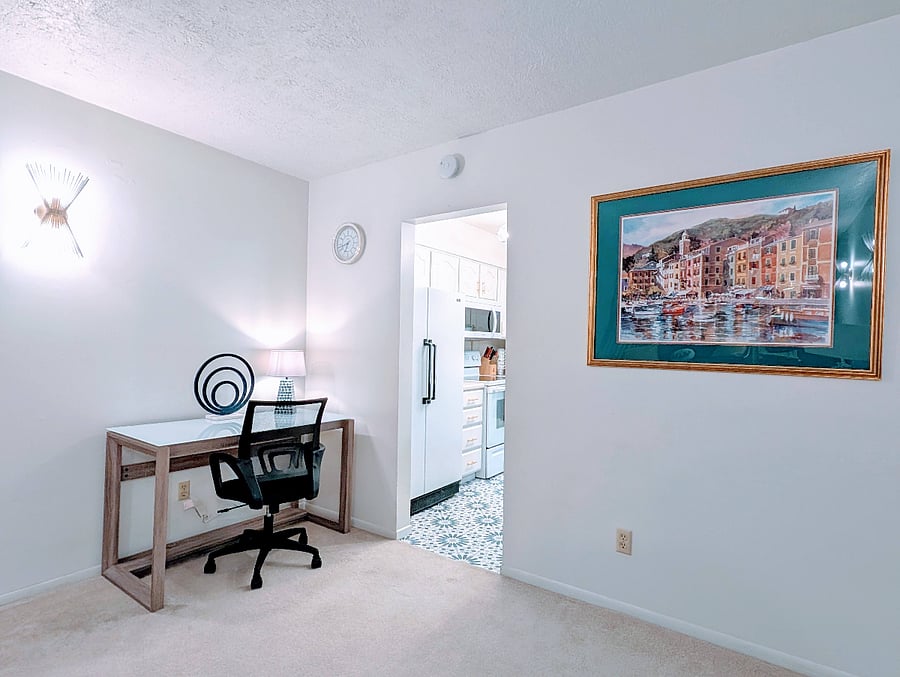 Large desk work area next to kitchen.