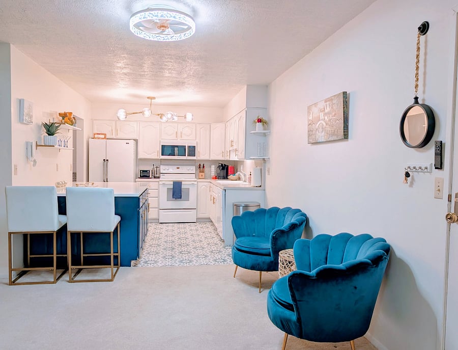 Large kitchen with quartz island and plenty of kitchen storage. Spacious entryway with seating.