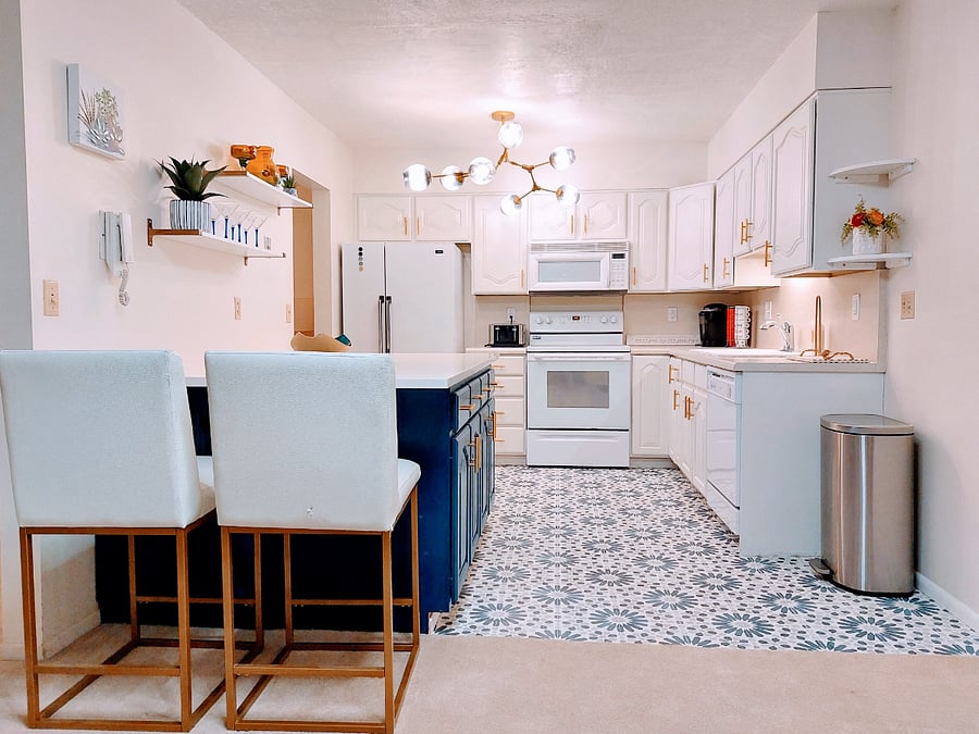 Large kitchen with quartz island and plenty of kitchen storage.