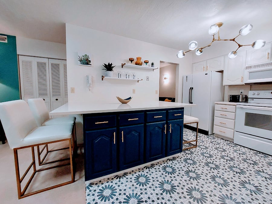 Large kitchen with quartz island and plenty of kitchen storage.
