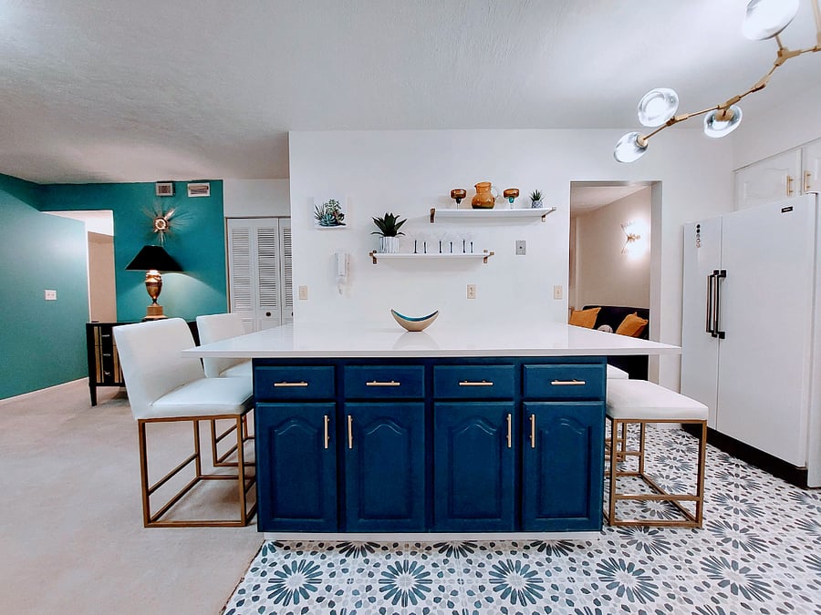 Large kitchen with quartz island and plenty of kitchen storage. Counter seats on either side.