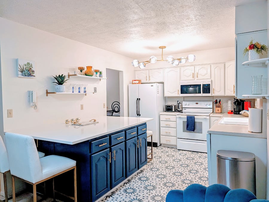 Large kitchen with quartz island and plenty of kitchen storage. Spacious entryway with seating.