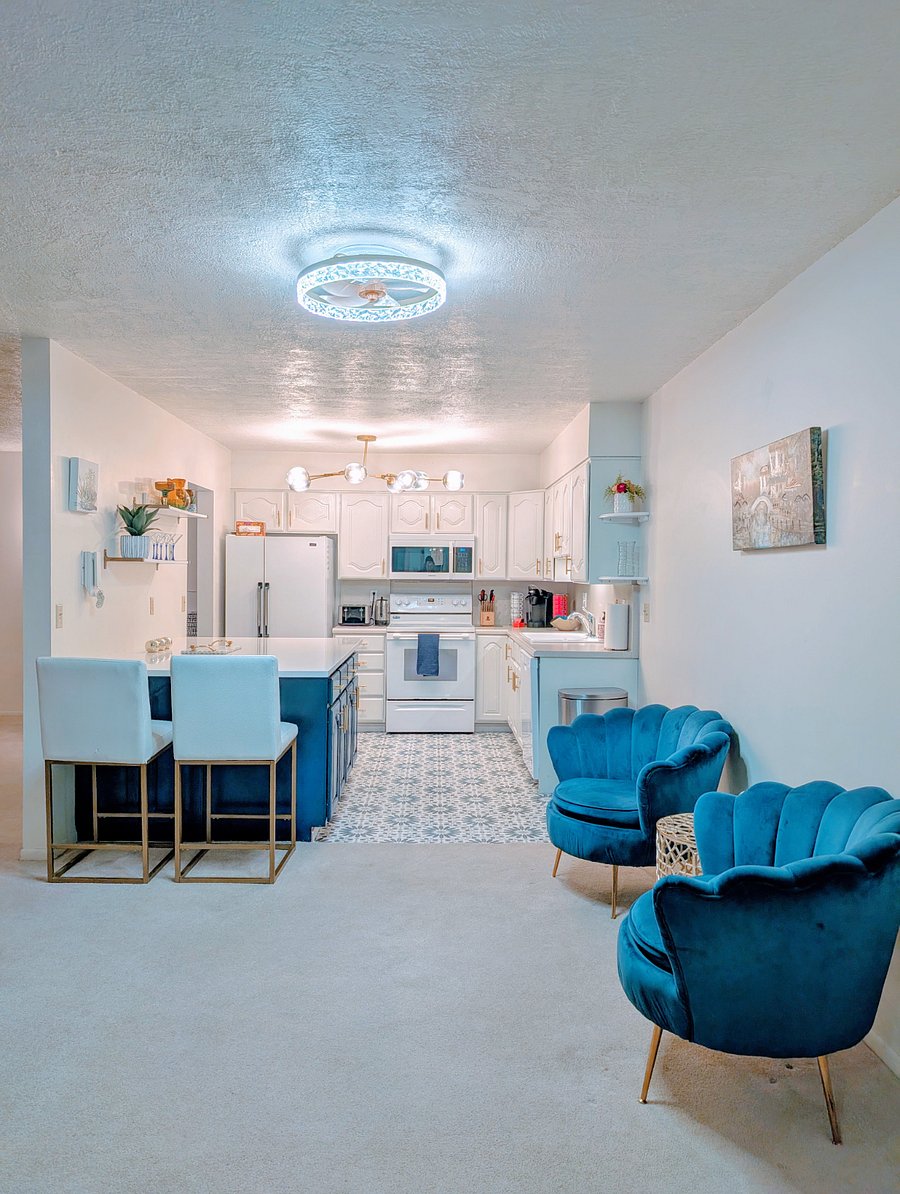 Large kitchen with quartz island and plenty of kitchen storage. Spacious entryway with seating.