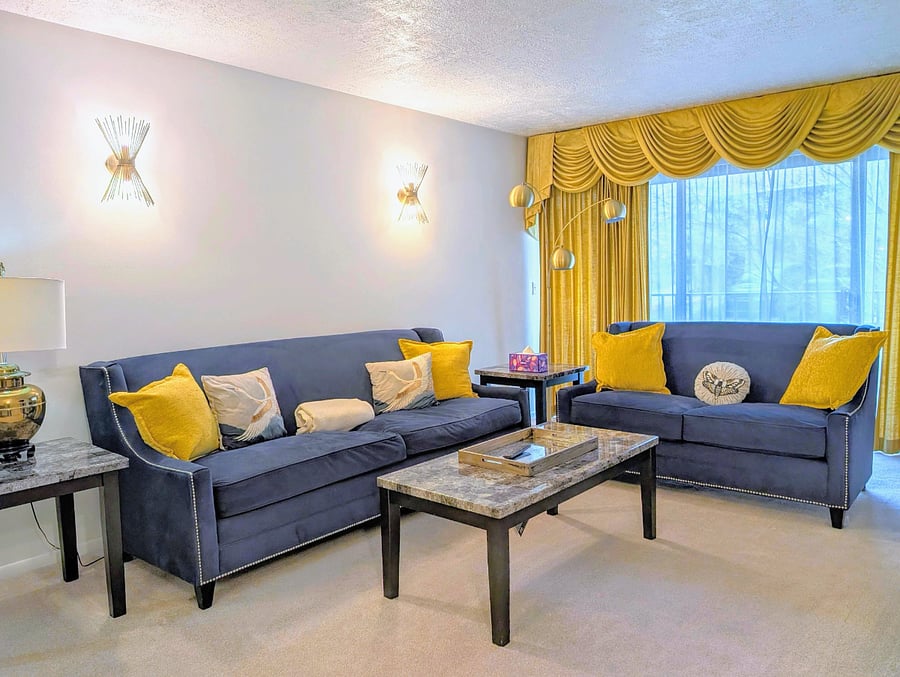Large living room with electric fireplace and TV