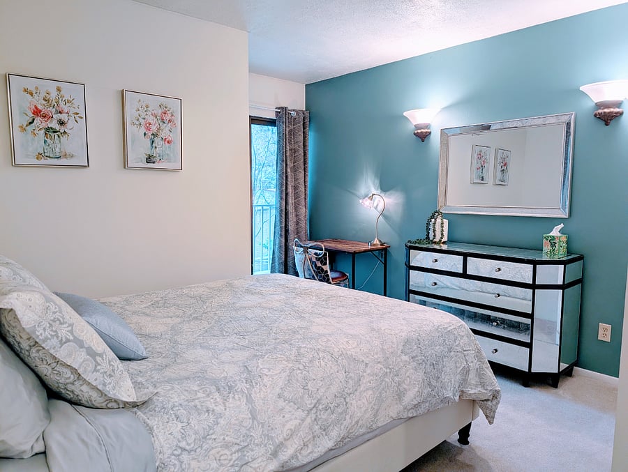 2nd bedroom with queen bed, large dresser and small desk area.
