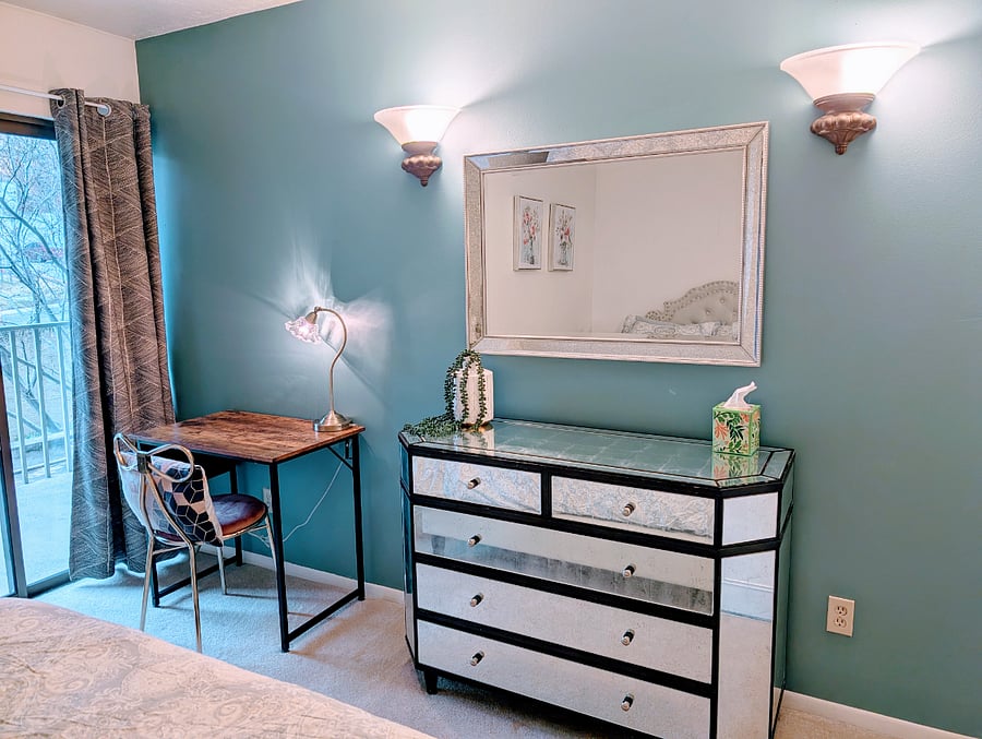 2nd bedroom with queen bed, large dresser and small desk area.