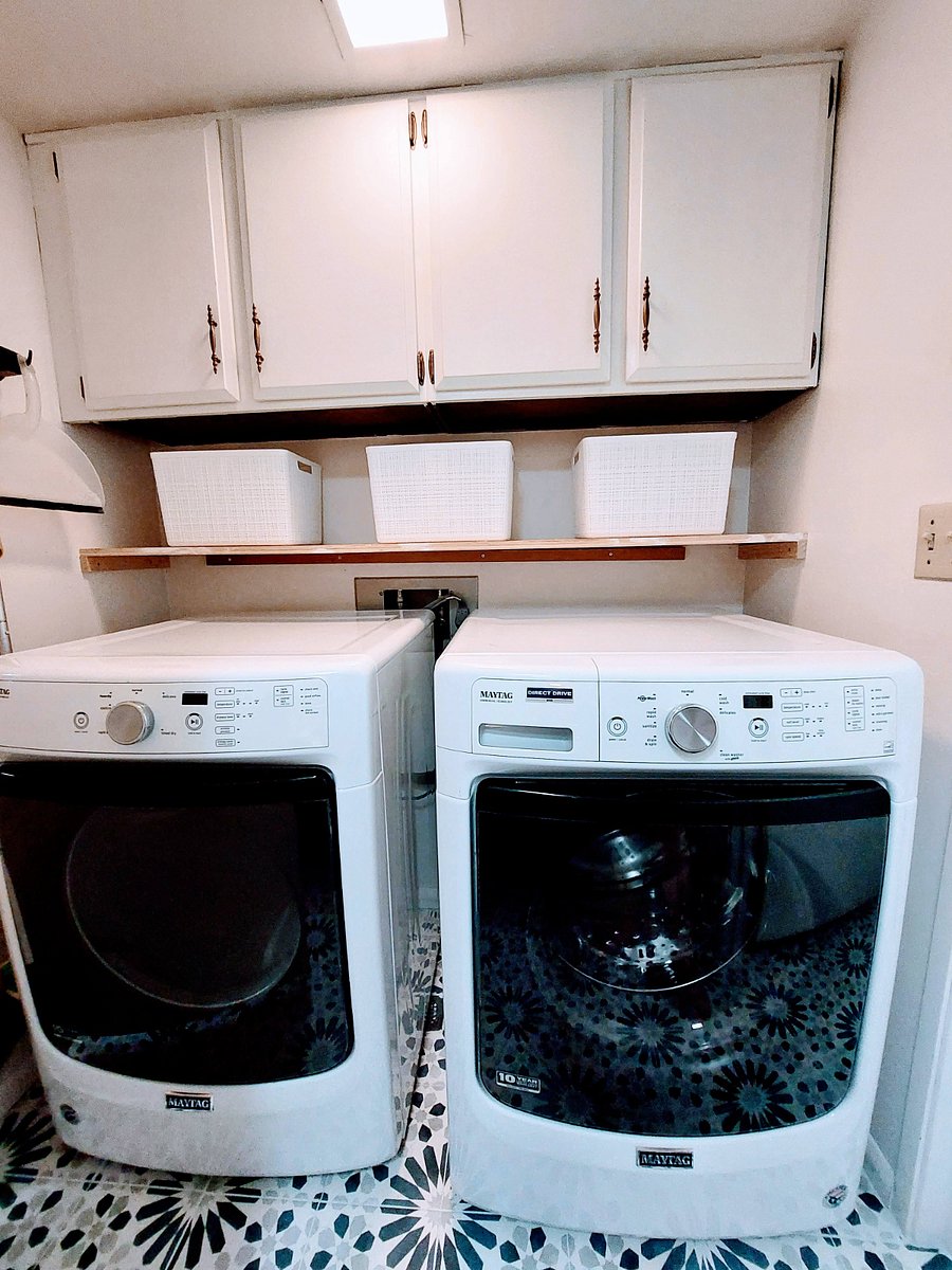 Laundry with storage in unit.