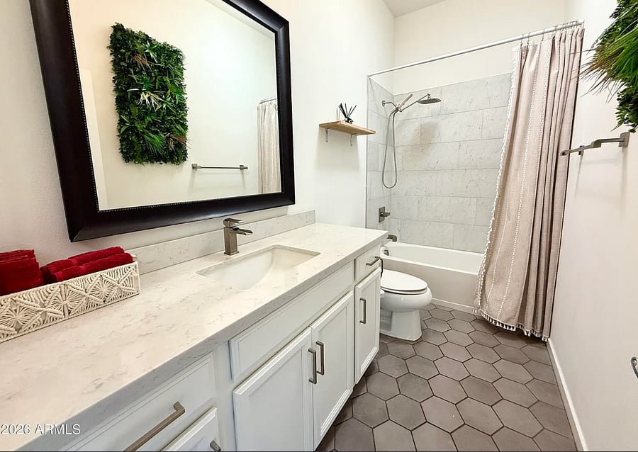 Clean, updated bathroom with full tub/shower and plenty of storage