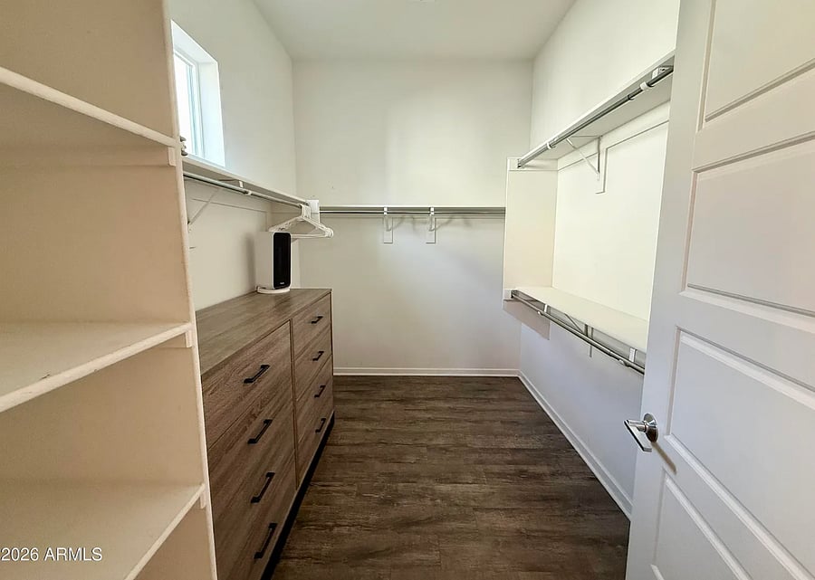 Master bedroom: Spacious walk-in closet with built-in shelving and plenty of storage.
