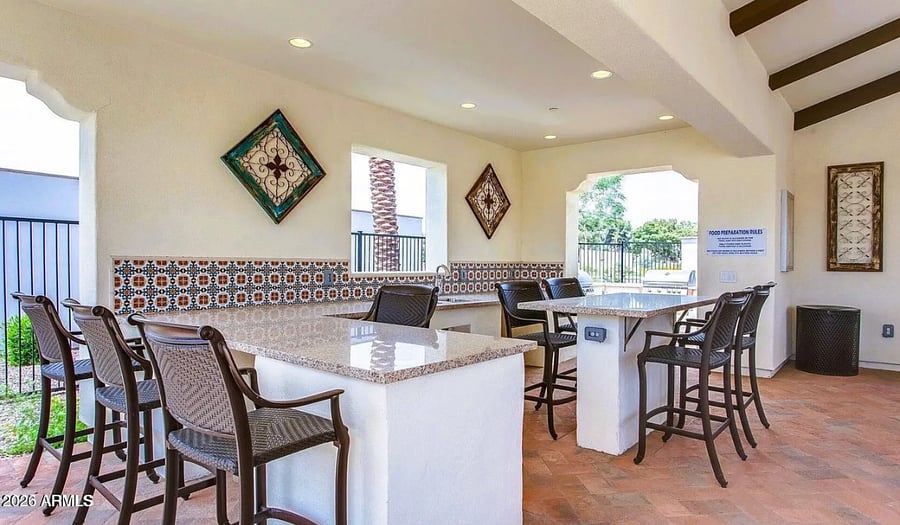 Resort-style outdoor kitchen and bar area, perfect for gathering.