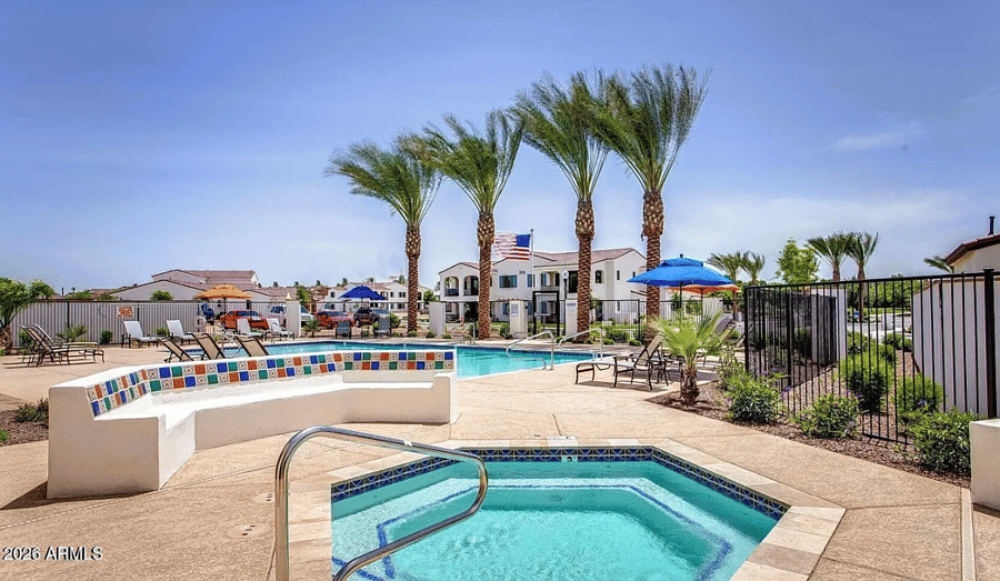 Sparkling pool and spa with resort-style lounge seating.