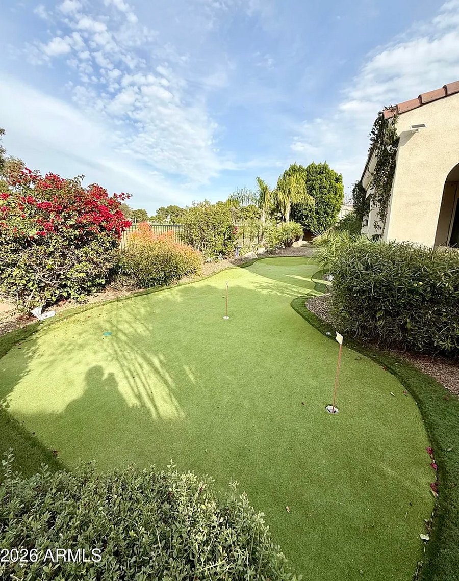 Inviting covered patio with comfortable seating and direct views of Wigwam Golf Course  perfect for relaxing mornings and sunsets.