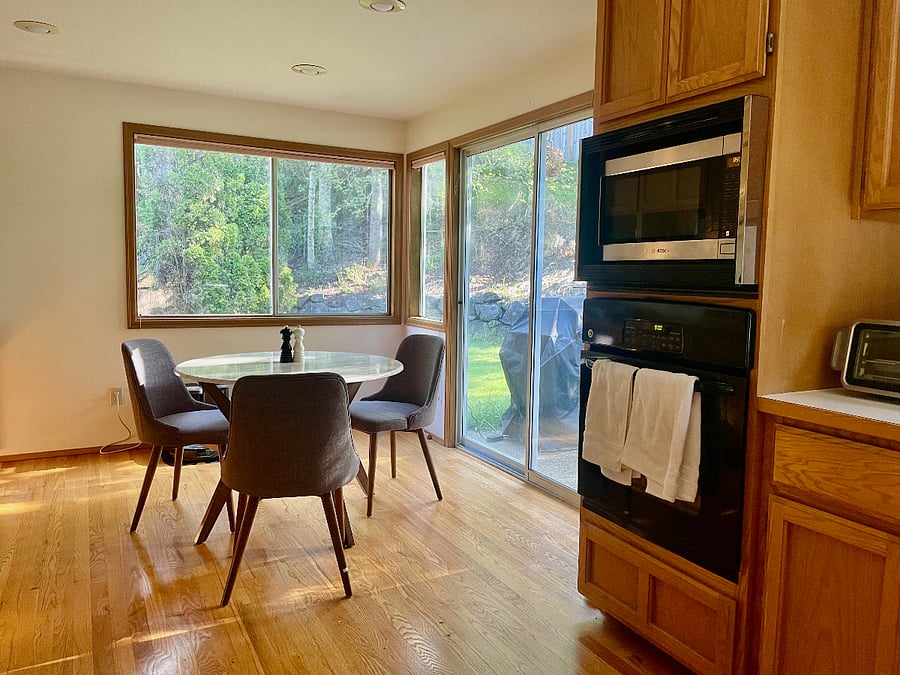 Glass doors leading out to the back yard with a grill.