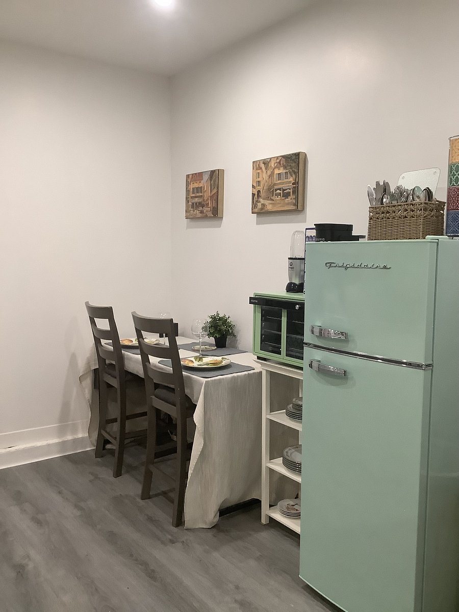 Kitchenette, refrigerator , dining table, Keurig coffee maker, toaster over, bullet blender, sink and cabinets for storage.