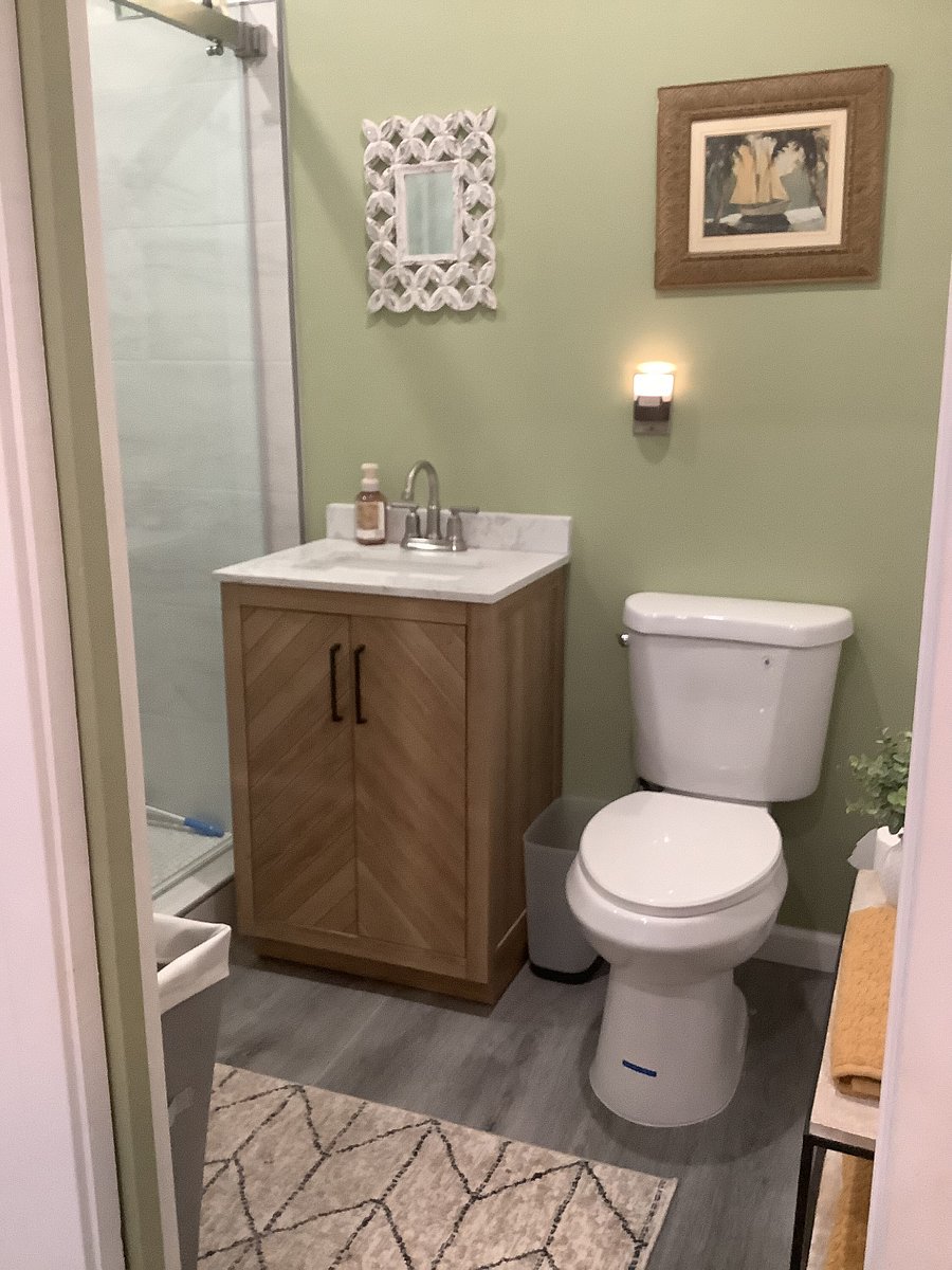 Bathroom toilet, cabinet sink within cottage