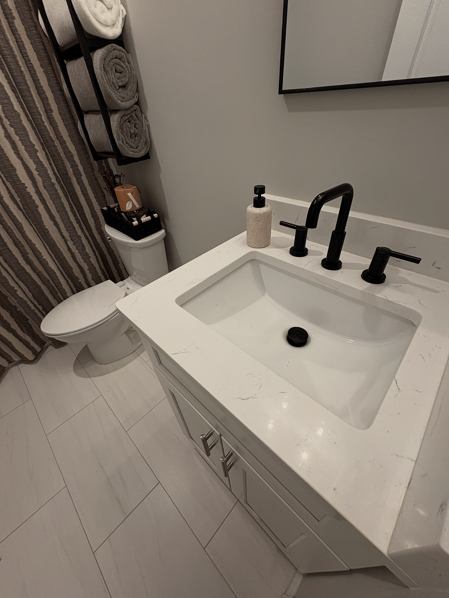 There is a locker being added between the sink and toilet with two separate top and bottom halves with locks and keys, one half belonging to each of the two rooms that share this bathroom.