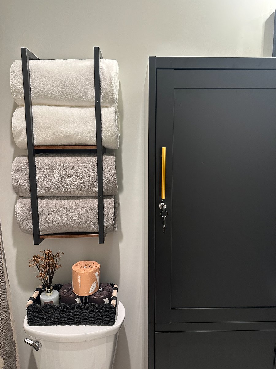 Large locker with two locked halves (top and bottom), one for each of the rooms who share this bathroom.