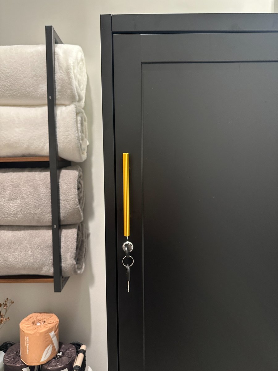 Large locker with two locked halves (top and bottom), one for each of the rooms who share this bathroom.
