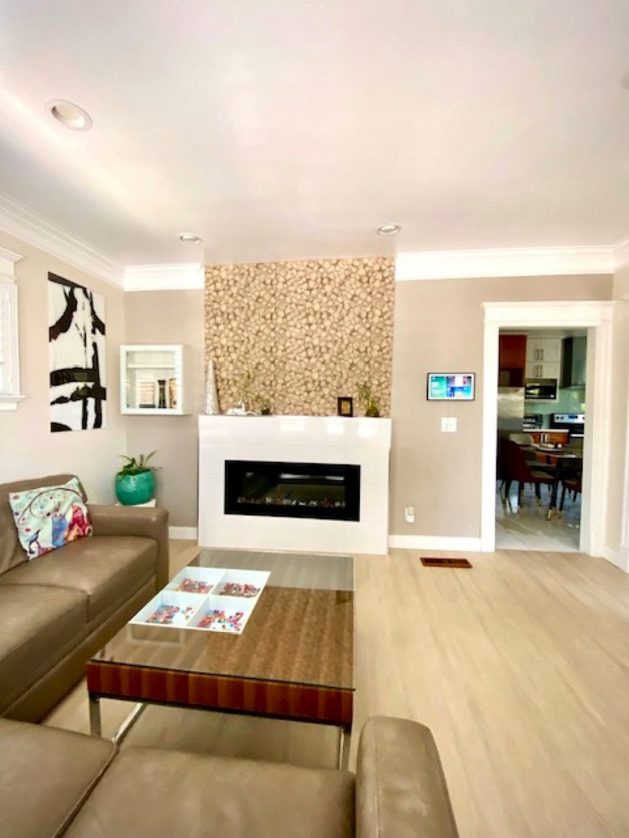Living Room: Enjoy the warmth of the built-in electric fireplace set against a beautiful leaf-textured tile wall. This inviting space combines natural charm with modern styleperfect for cozy evenings or a quiet movie night.