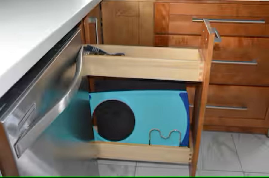 Kitchen: A convenient pull-out cabinet provides easy storage for the cutting board.