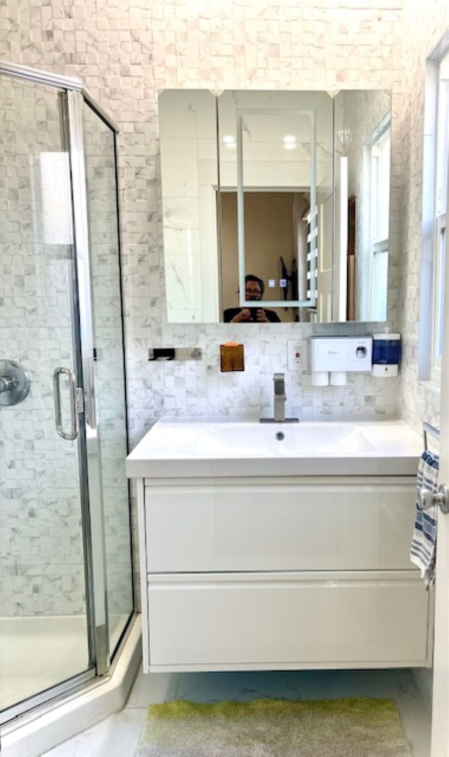 Bathroom #1: The floating vanity features an integrated ceramic sink with the smart touch-screen mirror vanity cabinet, front lighting, backlit anti-fog technology, and the dimmable memory functionenhancing both modern aesthetics and functionality