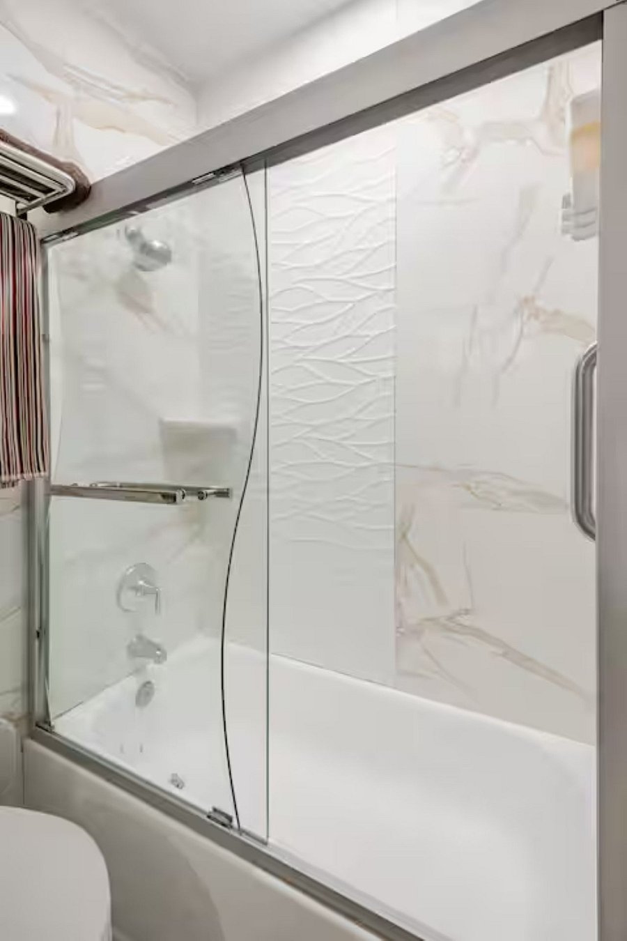 Bathroom 2: Fully tiled from floor to ceiling to maintain a clean, dust-free, and mold-resistant space. The upgraded towel warmer and rain shower add a spa-like touch, perfect for wrapping yourself in warmth after a relaxing shower.