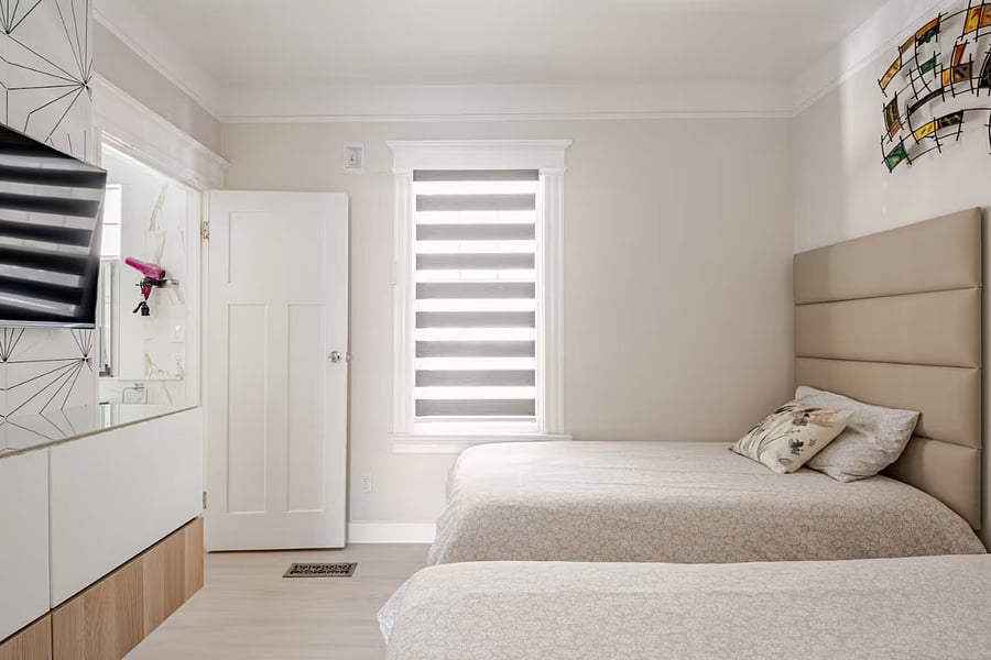 Bedroom #2 - 2 twin beds (Not bunks): Contemporary yet inviting, this room features a floating dresser and soft frosted glass that gently diffuses light. Thoughtful design elements and clean lines create a restful atmosphere with just the right balance of style and comfort.