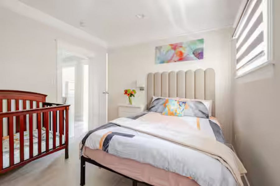 Bedroom #3 (queen bed): Unique leaf glass artwork brings natural beauty and a touch of vitality to the room. The modern leather wall panel and cozy bed create a perfect balance of comfort, technology, and contemporary design