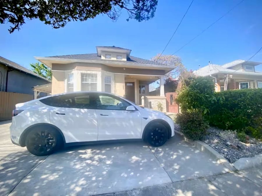 Exterior  Front of House: This charming Craftsman-inspired home welcomes you with classic windows, detailed trim, & a modern stucco finish. A cheerful front garden and spacious parking spot even for large tour vehicles make arriving easy & inviting.