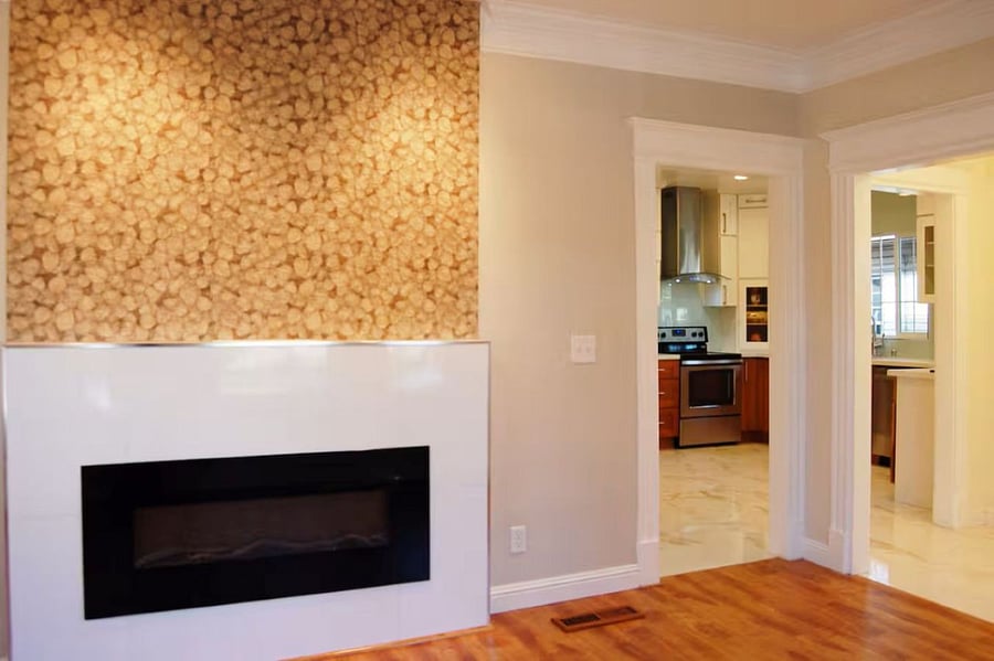 Living room: The organic leaf-textured tile accent wall with a built-in electric fireplace creates a cozy, stylish focal pointblending natural elegance with modern comfort. Ideal for quiet mornings with coffee or relaxing nights with a good movie.