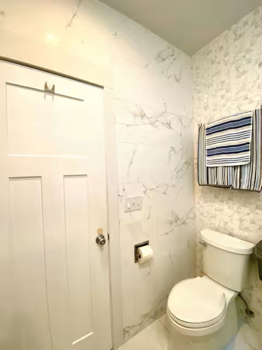 Bathroom 1 : The bathroom features an electric towel warmer rack and a built-in toilet paper holder for added convenience and comfort
