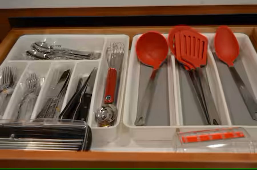 Kitchen: A convenient drawer stores cookware and silverware, keeping essentials within easy reach.