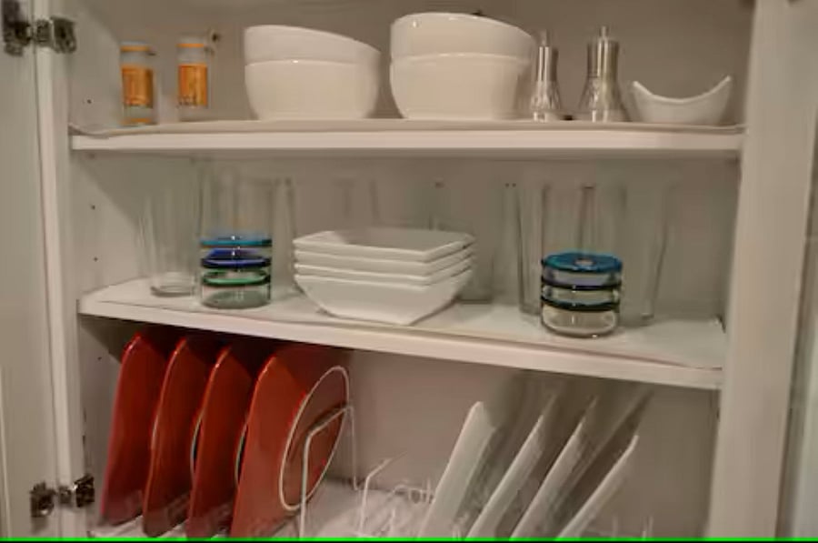 Kitchen: Thoughtfully designed with an organizer rack for dining ware and a glass cabinet that provides both easy access and stylish storage