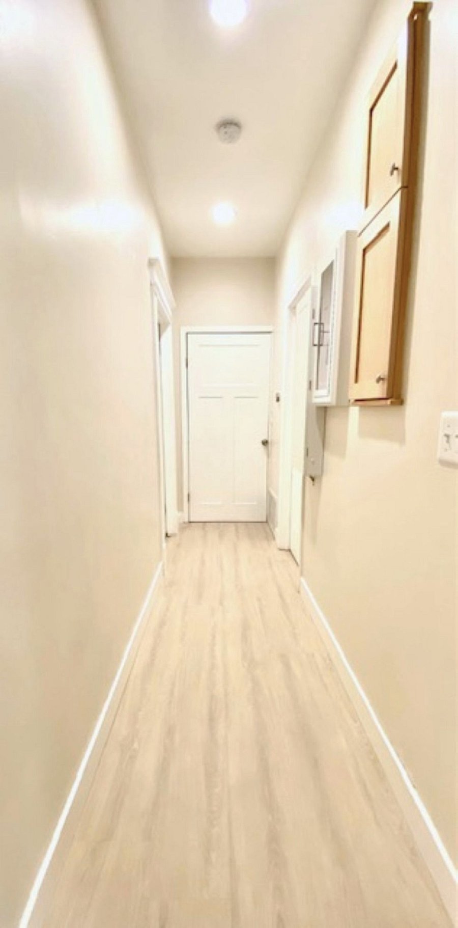 Hallway: The hallway to the laundry room combines safety and smart design. A wall-mounted fire extinguisher cabinet ensures quick emergency access, while a built-in ironing board offers a sleek, space-saving solution for everyday laundry care.