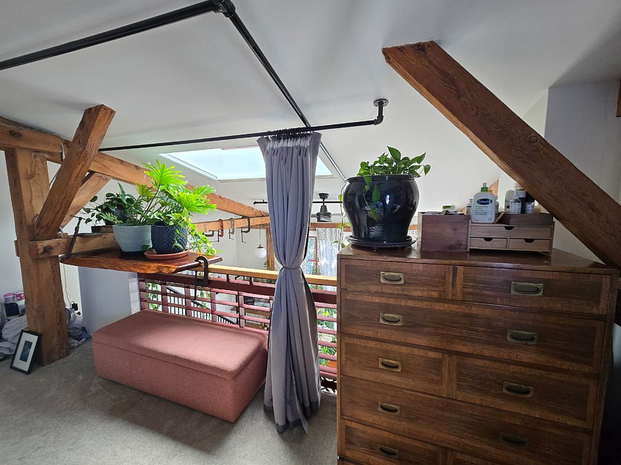 3rd Floor - Bedroom Loft with huge operable skylight, and full length blackout shade curtains. large dresser and storage ottoman