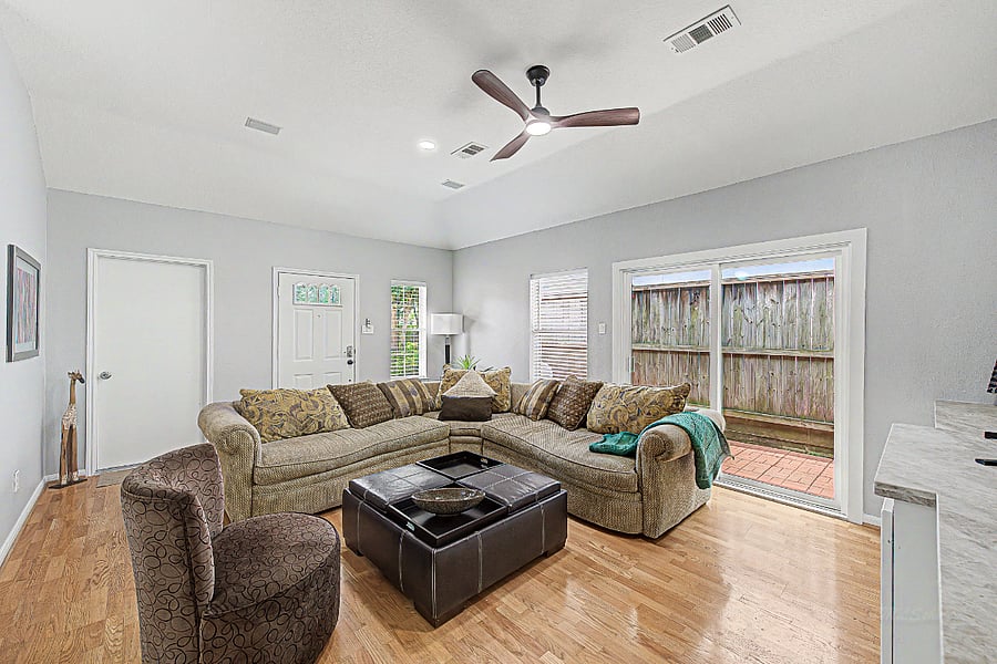 Family room with sliding door to patio and door to access to garage