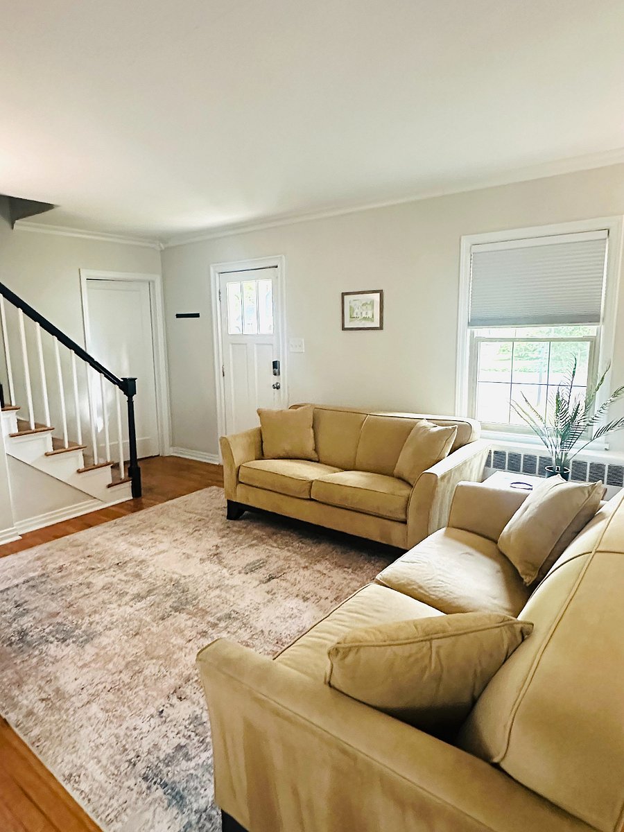 Living room w/ 2 couches, and 60 inch smart tv; perfect for relaxation.