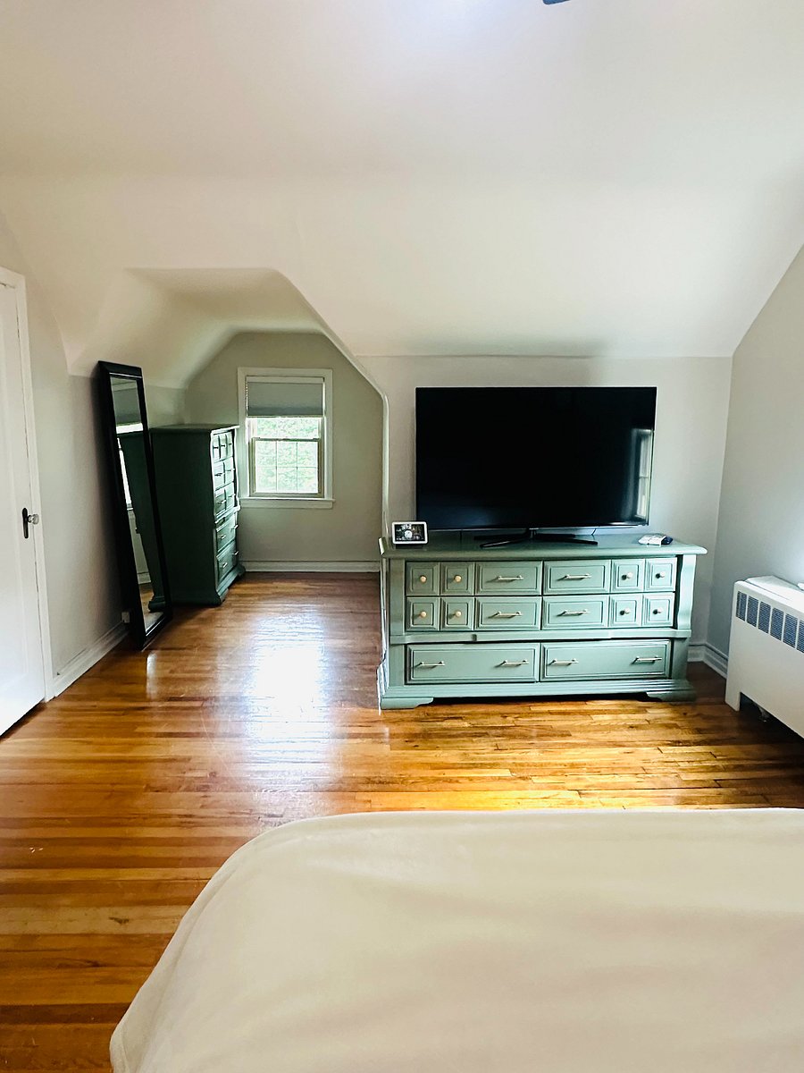Upstairs Master Bedroom w/ walk-in closet and 55 inch smart TV.